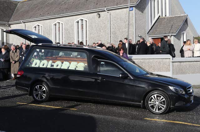A hearse leaves following the funeral (Niall Carson/PA)