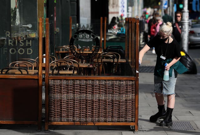 Worker cleans outside dining area at Dublin restaurant