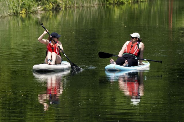 Two paddleboarders enjoy the warm weather on the Jubilee River in Taplow near Maidenhead, Buckinghamshire on Thursday May 25, 2023