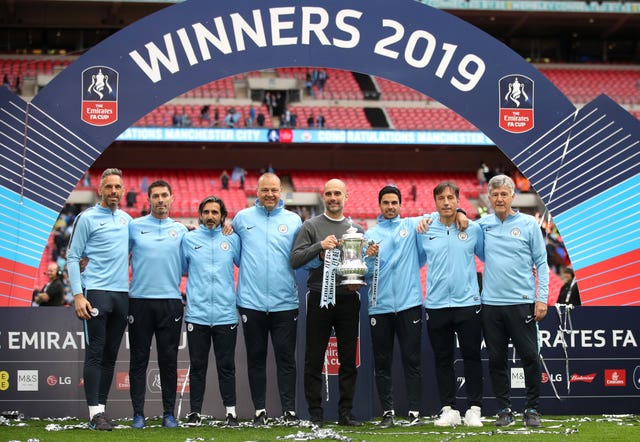 Arteta (third from right) and the other coaching staff with the FA Cup Trophy won by Manchester City in 2019 