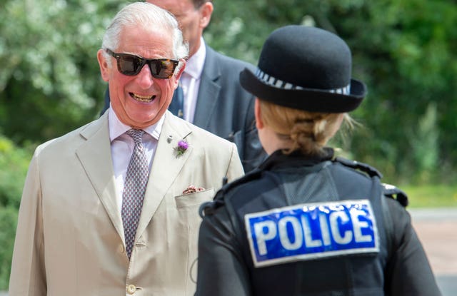 Charles talks to a police officer (Paul Grover/Daily Telegraph/PA)