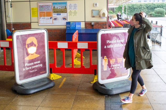 A shopper wearing a face mask outside a Sainsbury’s store