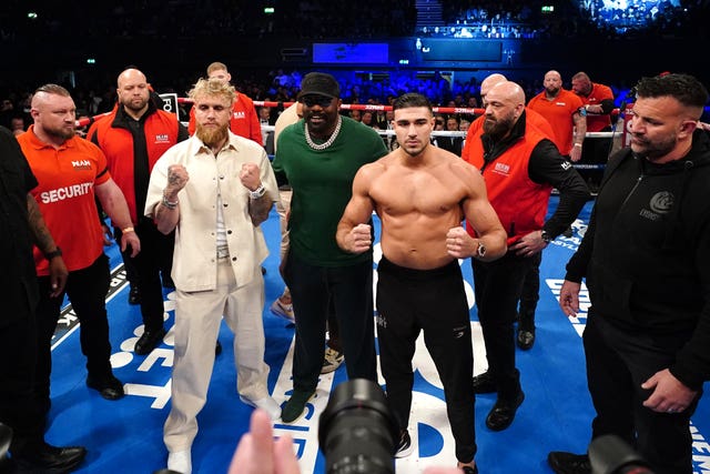 Jake Paul, left, and Tommy Fury pose after a face-off in the ring