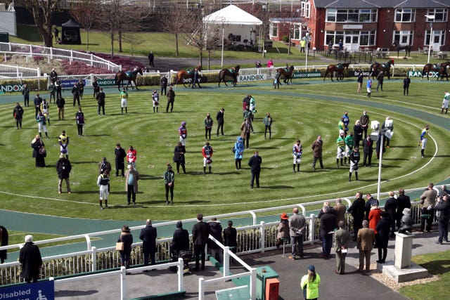Jockeys, owners and trainers also stood for a two-minute silence at Aintree in Liverpool 