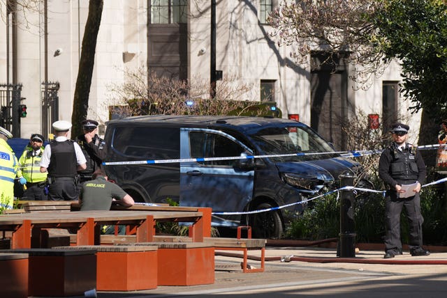 Police and the blue van at the scene in central London