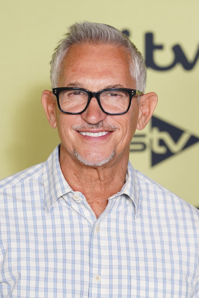 Gary Lineker wearing a white checked shirt wearing black glasses