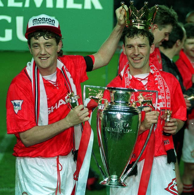 Manchester United captain Steve Bruce and Bryan Robson with the Premier League trophy