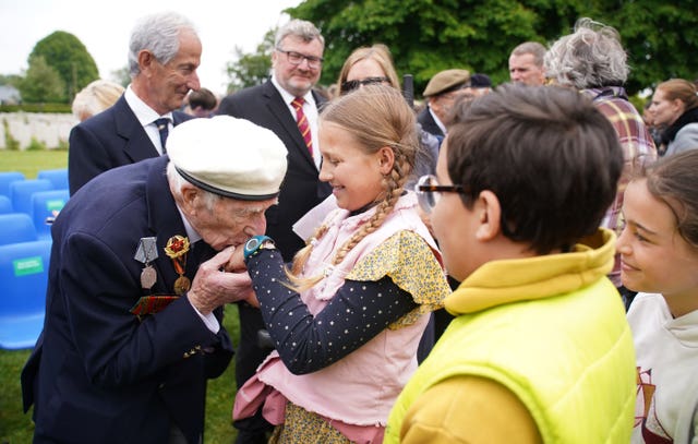 D-Day veteran Alec Penstone meets local children after the service 