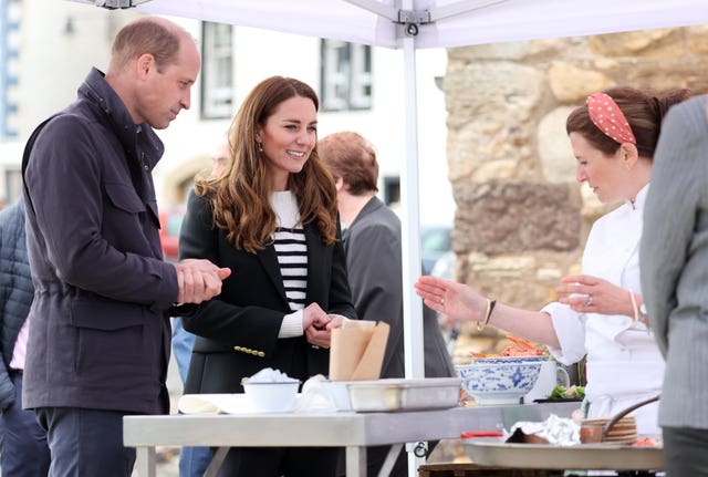 The Duke and Duchess of Cambridge look at local produce after meeting fishing families (Chris Jackson/PA)