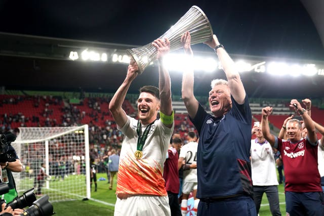 West Ham’s Declan Rice, left, and manager David Moyes lift the Europa Conference League trophy