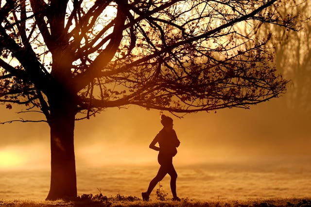 A person running on a misty morning