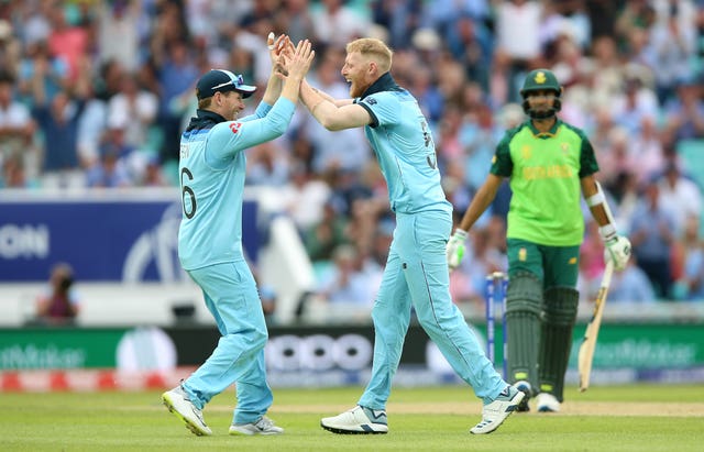 Ben Stokes celebrates a wicket with captain Eoin Morgan, left