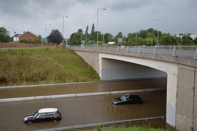 Cars stranded in flood water on the A555 near Handforth, Greater Manchester