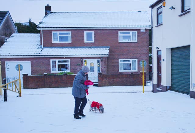 A woman walks in snow