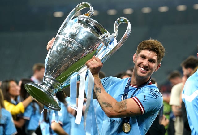 John Stones holds the Champions League trophy