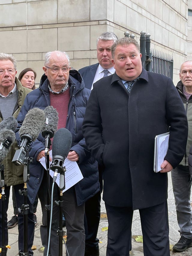 Ciaran Shiels, second from right, solicitor for the Bloody Sunday families speaks to the media outside Belfast Crown Court on Friday