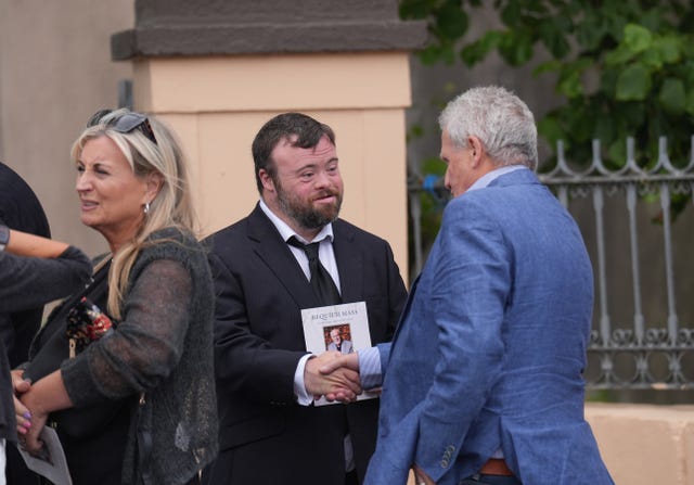 From left, Lynda Bryans, James Martin and journalist Chris Moore leave after the funeral of Gerry Kelly at St Nicholas Church in Ardglass, Co Downl
