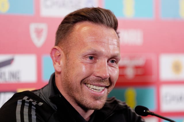 Craig Bellamy smiles at a Wales press conference