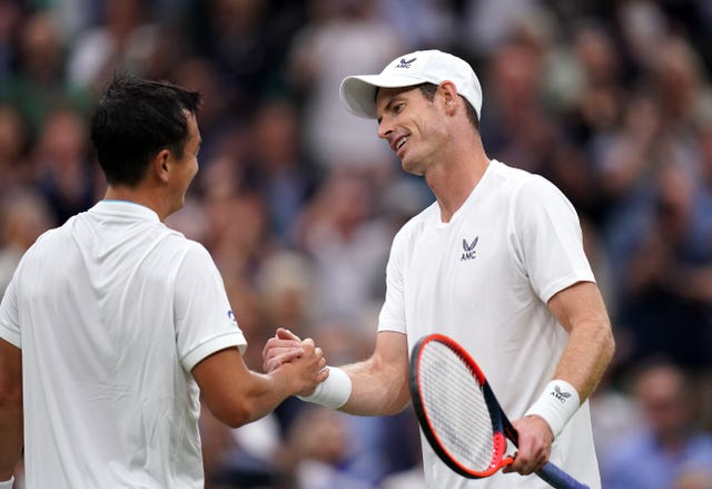 Andy Murray shakes hands with Ryan Peniston (left) after their match on Centre Court 