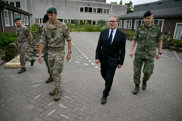 Sir Keir Starmer walking with some marines
