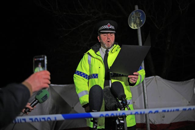 Chief Superintendent Neil Blackwood reads a statement to the media at the scene 