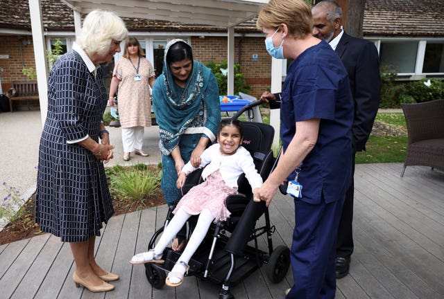 The Duchess of Cornwall meets parents Vaida and Aqsad Ali and their daughter Fatima, nine, during a visit to the Helen & Douglas House children’s hospice in Oxford 
