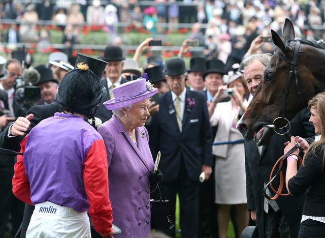 Queen Elizabeth II looks at her horse Estimate alongside jockey Ryan Moore after the Gold Cup at Ryan Ascot 