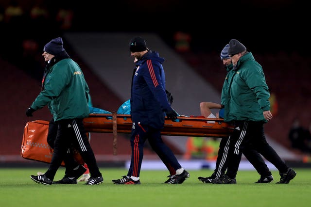 Arsenal forward Vivianne Miedema is carried off on a stretcher
