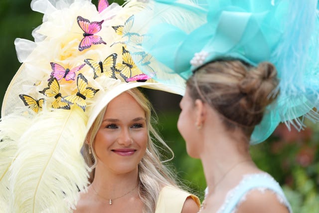 A woman wears a hat with a butterfly design