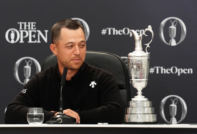 Xander Schauffele looks at the Claret Jug in his winners' press conference