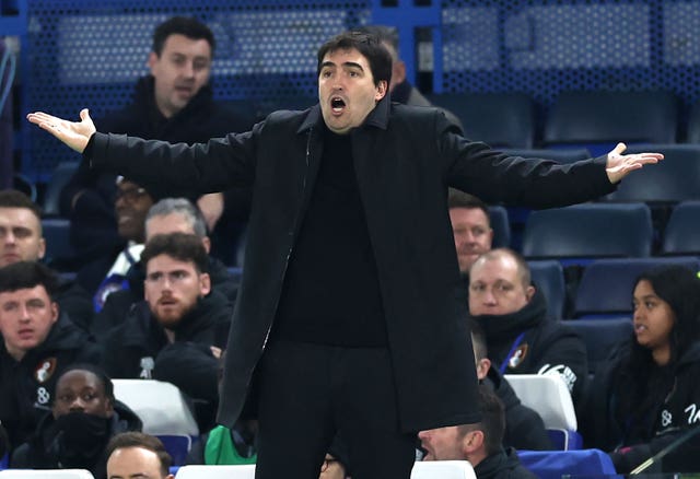 Andoni Iraola holds his arms out in frustration on the touchline