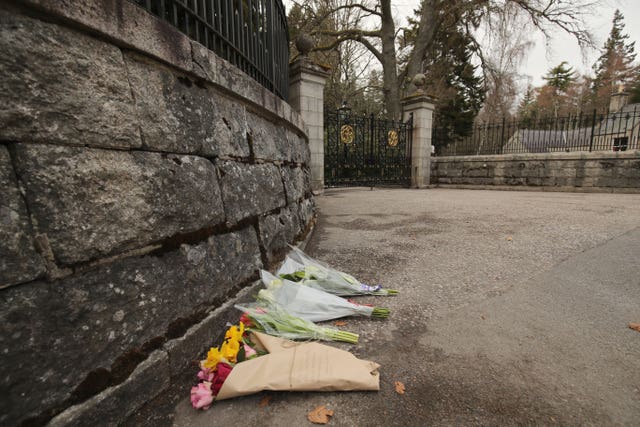Floral tributes outside the gates at Balmoral Castle, Aberdeenshire (Jane Barlow/PA)