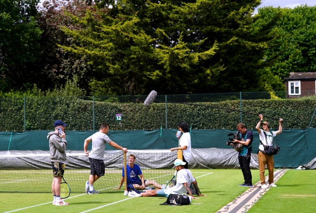 Nick Kyrgios is being filmed by a camera crew at Wimbledon