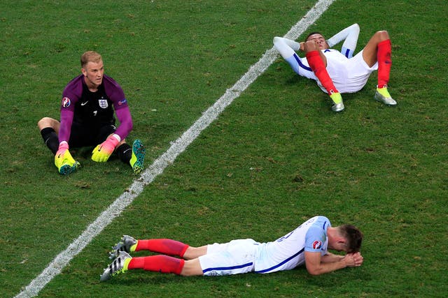 England players lie on the pitch after their shock Euro 2016 loss to Iceland