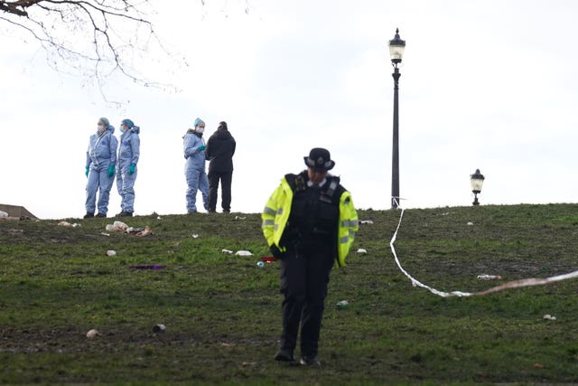 Police officers in forensic suits on Primrose Hill, Camden, north London 