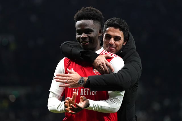 Bukayo Saka, left, celebrates with Arsenal manager Mikel Arteta after victory over Tottenham