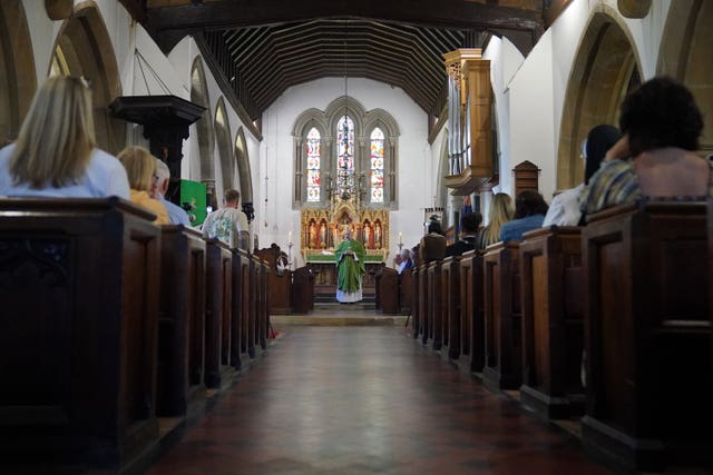 Father Stevenson delivers a sermon to members of the public attending a morning service and vigil at St James’s Church in Bushey, following the deaths of Carol Hunt, 61, the wife of BBC 5 Live racing commentator John Hunt, and two of their daughters, Hannah, 28, and Louise, 25, who were killed in a crossbow attack at their home on Tuesday in Bushey, Hertfordshire 