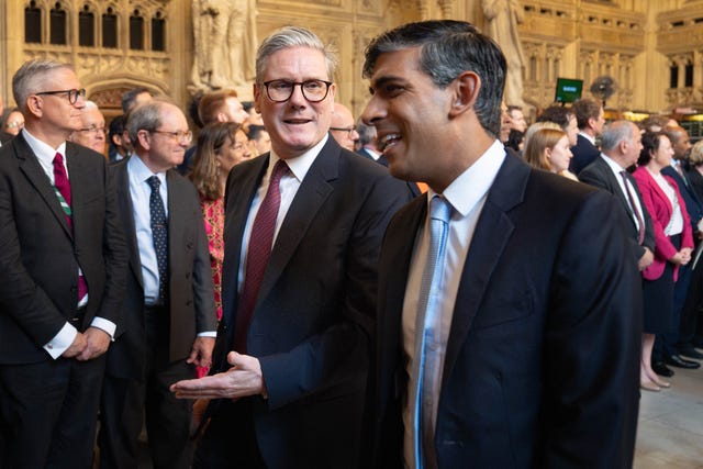 Sir Keir Starmer and Rishi Sunak chat to each other as they walk through Parliament