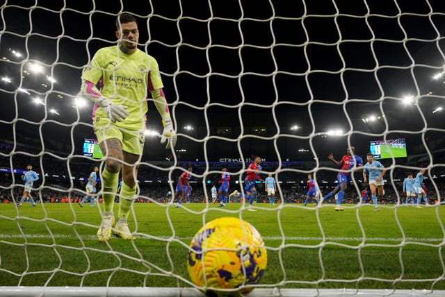 Manchester City goalkeeper Ederson picks the ball out of his net after Crystal Palace''s equaliser 