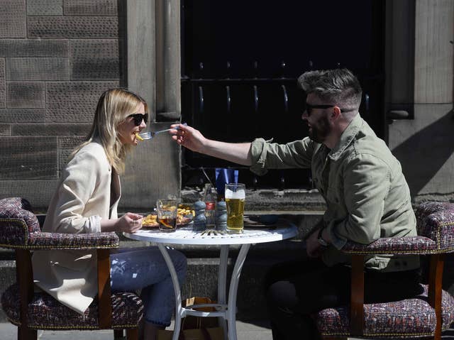 Members of the public enjoy a drink and a meal in Belfast