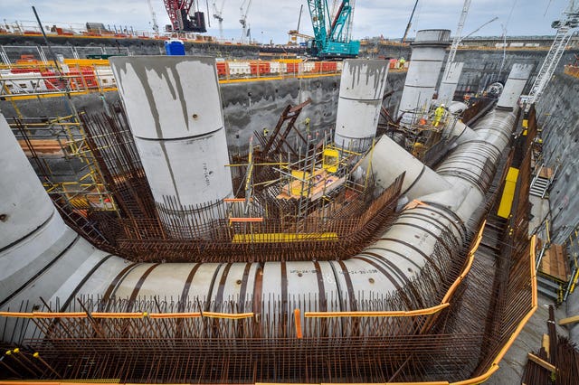 A worker inspects giant water cooling pipes during construction work at Hinkley Point C power station near Bridgwater, Somerset 