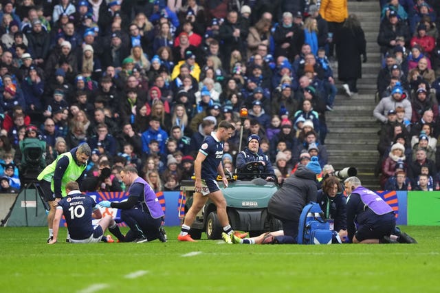 Finn Russell and Darcy Graham, right, receive treatment after colliding