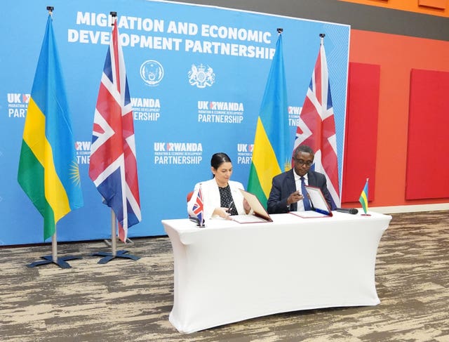 Priti Patel signing an agreement in Rwanda 