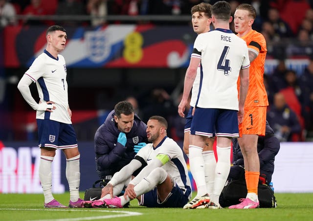 Kyle Walker, centre, receives treatment for an injury