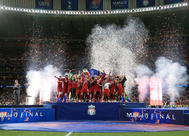 Liverpool’s Jordan Henderson lifts the trophy with his team-mates