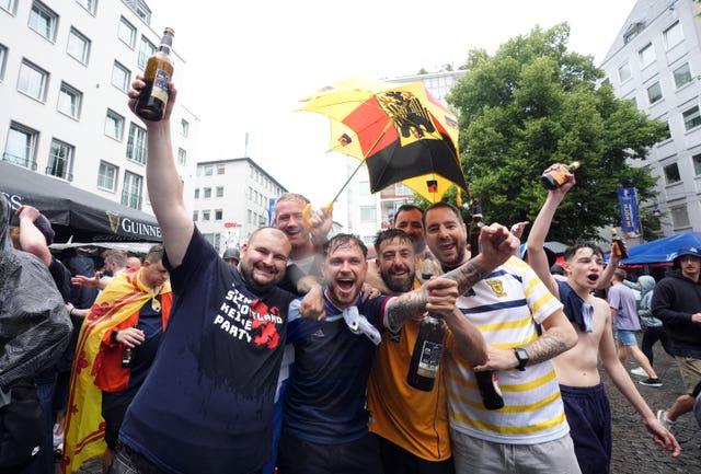 Scotland fans in the rain at the Old Market, Cologne ahead of the Euro 2024 match against Switzerland
