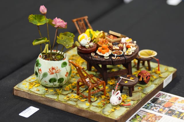 A cake which depicts a kitchen table coverd in food dishes