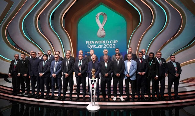 England manager Gareth Southgate (back row, third left) on stage during the World Cup Qatar 2022 Draw at the Doha Exhibition and Convention Centre
