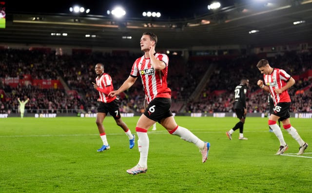 Taylor Harwood-Bellis puts his finger to his ear after scoring for Southampton