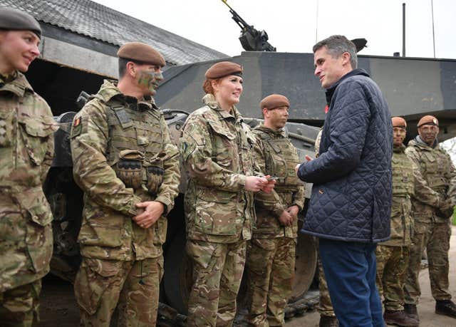 Gavin Williamson speaks to Royal Wessex Yeomanry Tank Gunner reservist Lance Corporal Kat Dixon, third left, during a Land Combat demonstration featuring women in command posts at Copehill Down Village on Salisbury Plain